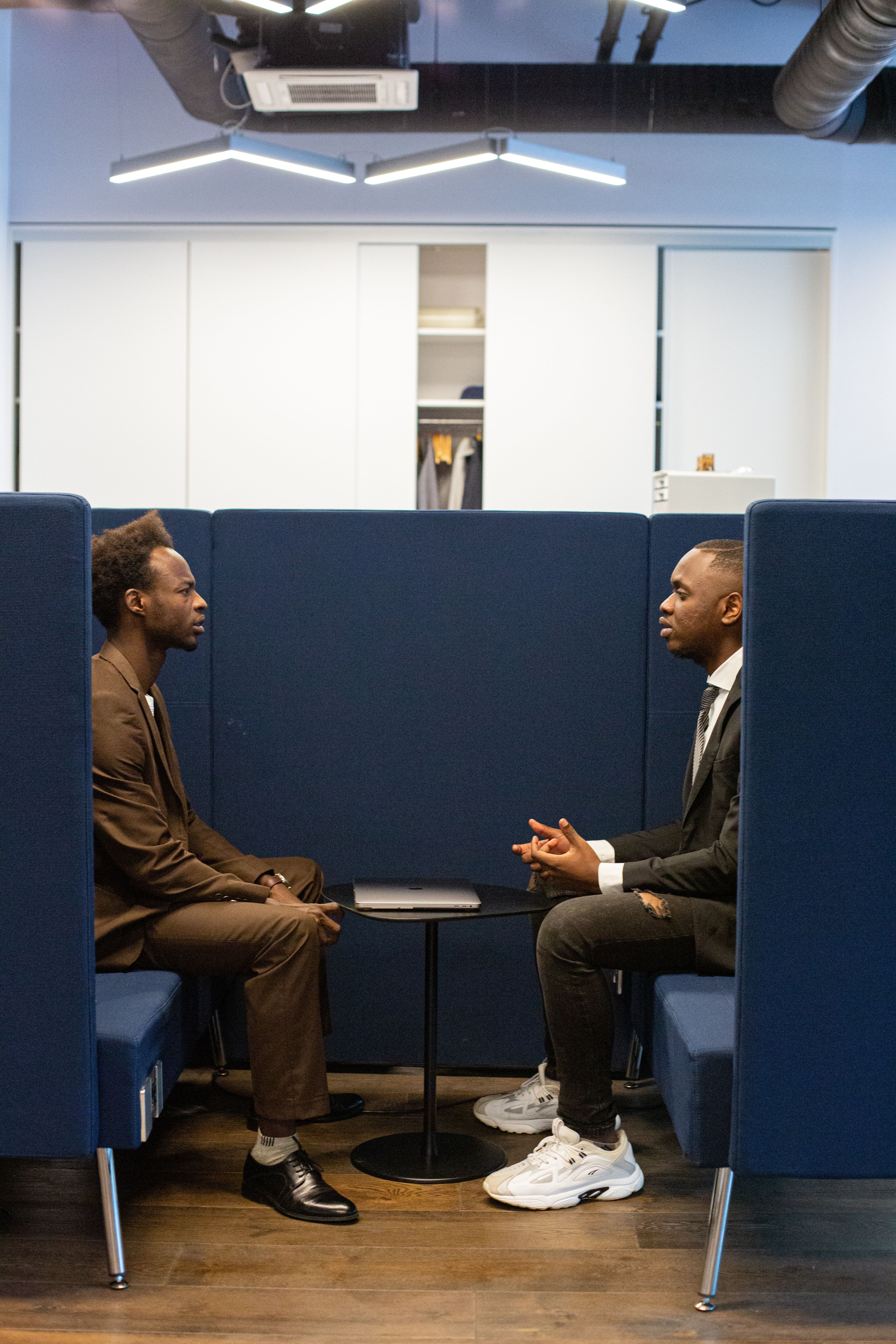 Two Black professionals in a focused conversation