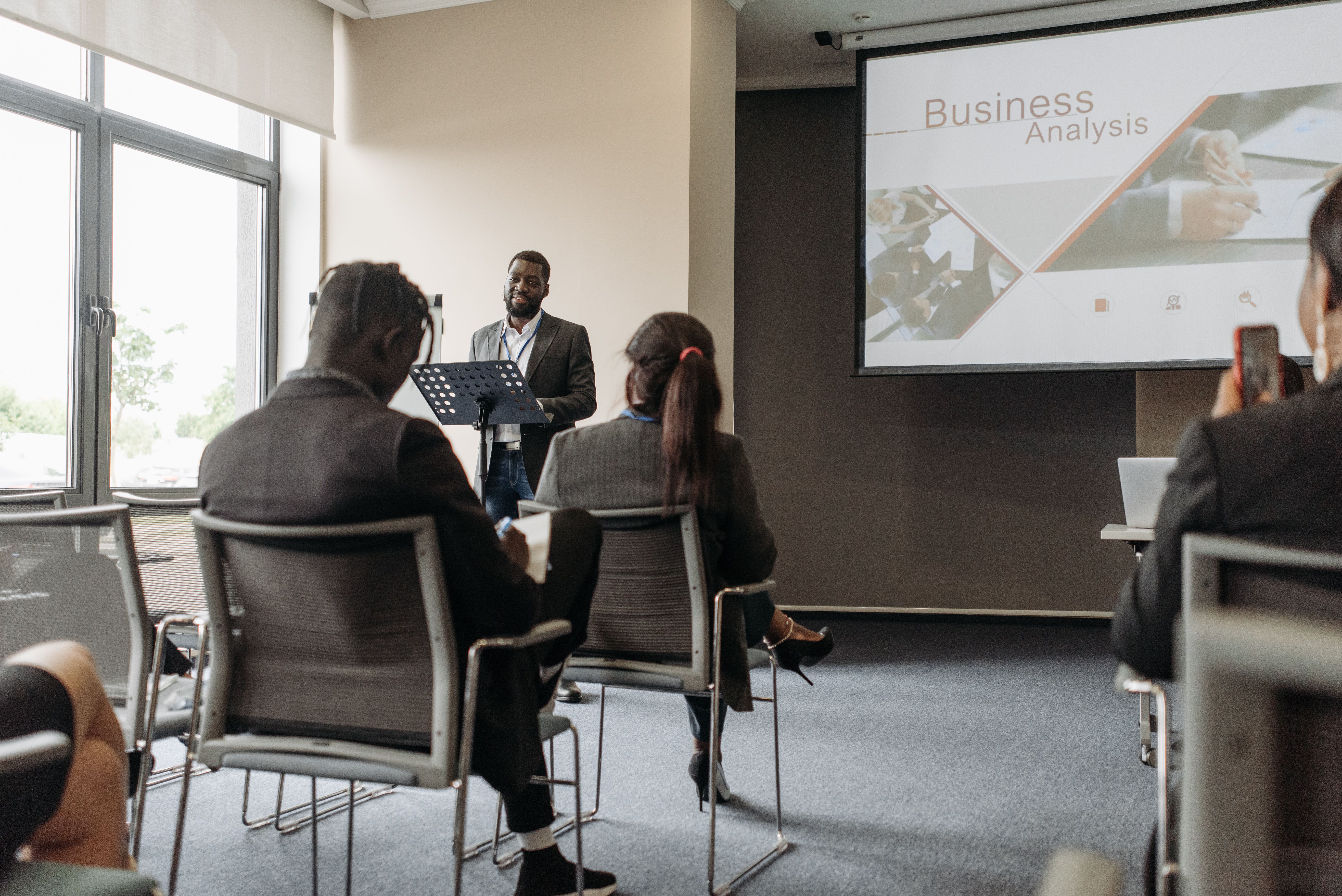 A Black innovator presenting to a room