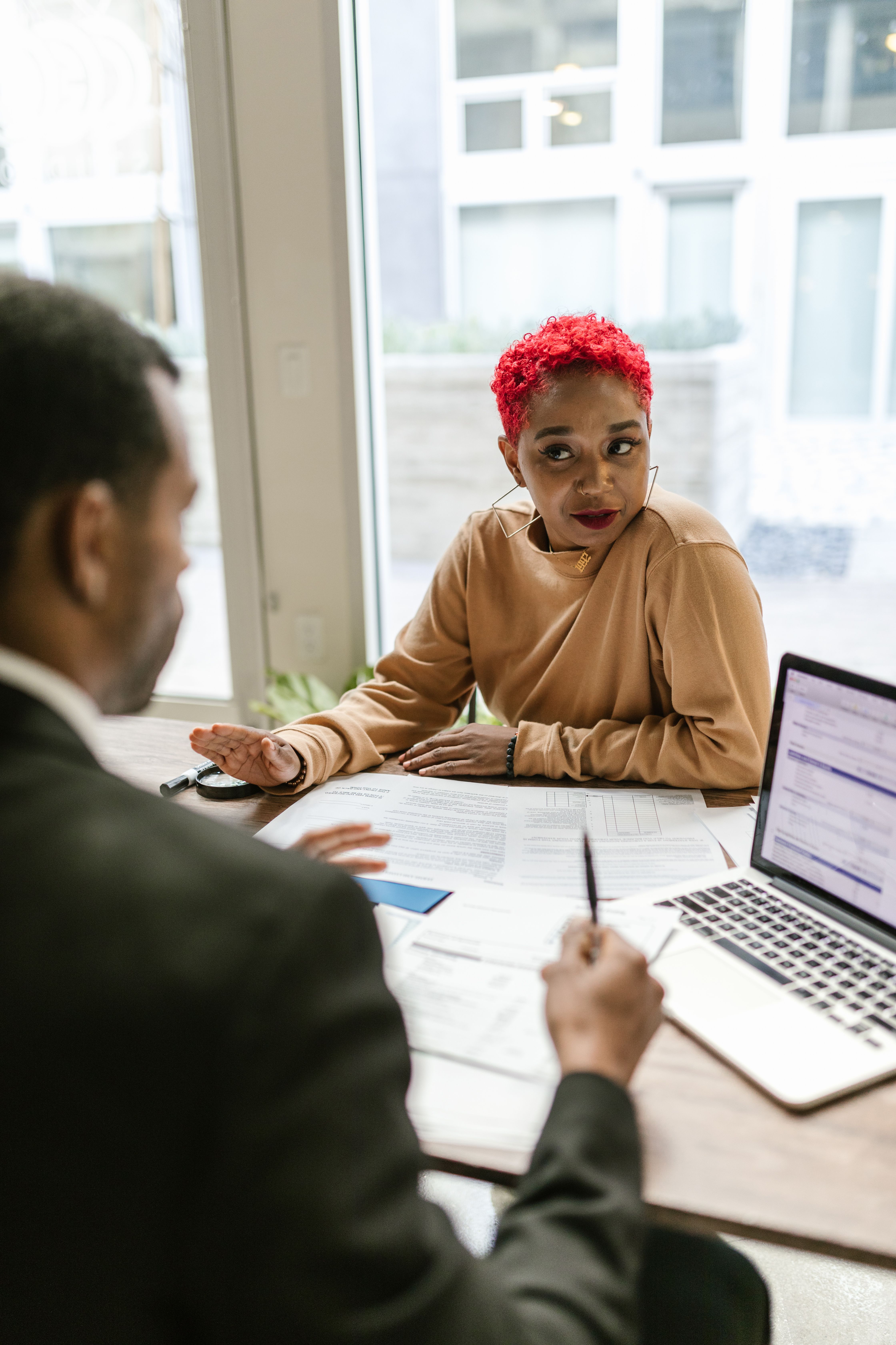 Two Black professionals working through a strategic question